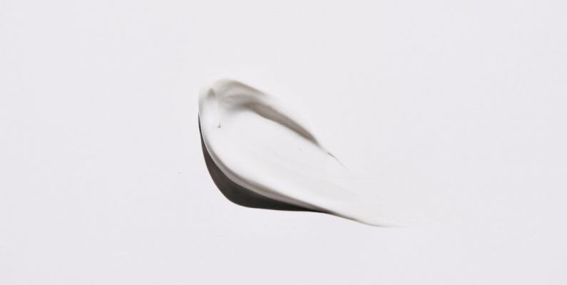 Skincare Trend - stainless steel spoon on white surface