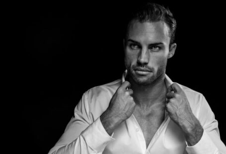Men Grooming - grayscale portrait of man wearing white dress shirt on black background