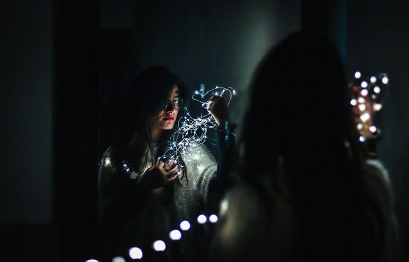 Makeup Gadgets - woman holding fairy lights