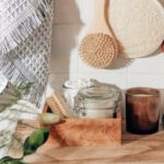 Sustainable Home - brown wooden chopping board beside clear glass jar