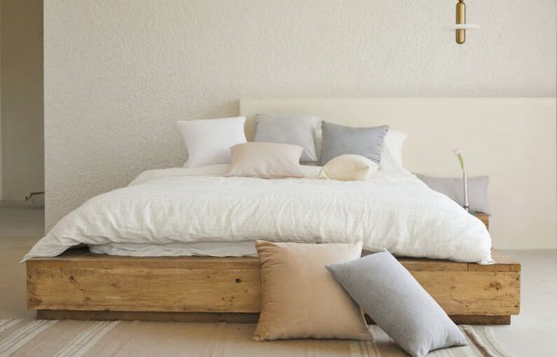 Minimalist Decor - white bed pillow on brown wooden bed frame