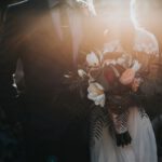 Wedding Savings - groom beside bride holding bouquet flowers
