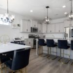Open Floor Plan - Black Chairs by White Table and Kitchen Island
