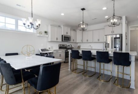 Open Floor Plan - Black Chairs by White Table and Kitchen Island