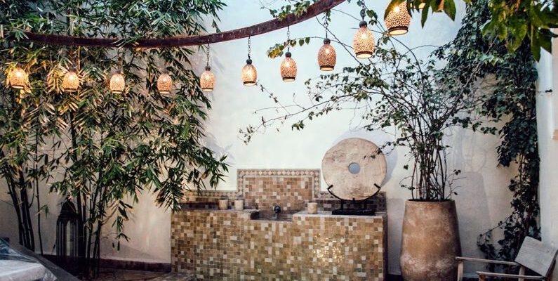 Luxury Authentication - Traditional oriental hammam pool on exotic resort spa terrace decorated with lush plants and stylish lanterns