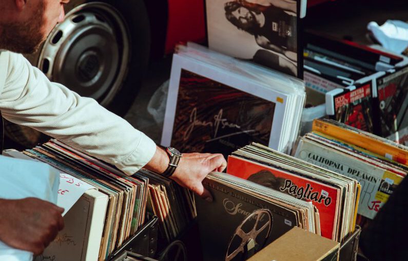 Tech Vintage - person holding vinyl records