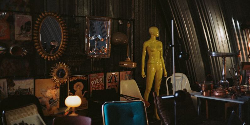 Vintage Decor - gold statue near red chair