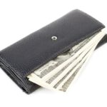 Luxury Savings - a wallet with money sticking out of it