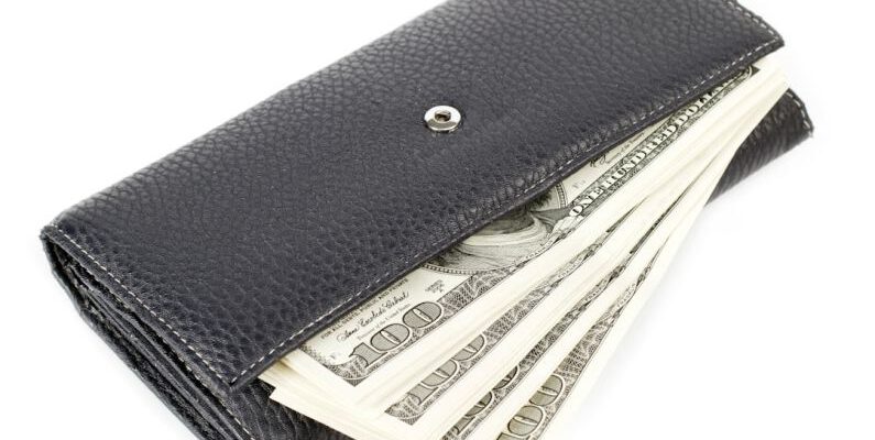Luxury Savings - a wallet with money sticking out of it