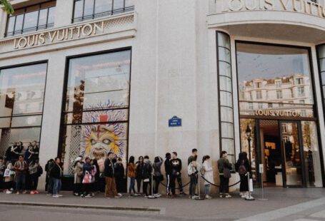 Luxury Shopping - people queuing beside Louis Vuitton store