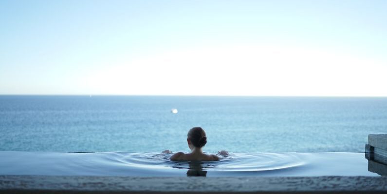 Luxury Travel - woman in water pool