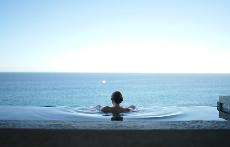Luxury Travel - woman in water pool