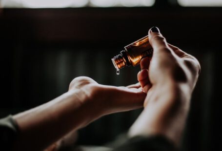 Luxury Care - person holding amber glass bottle