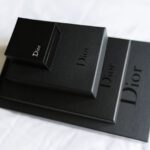 Luxury Gifts - a couple of black boxes sitting on top of a bed