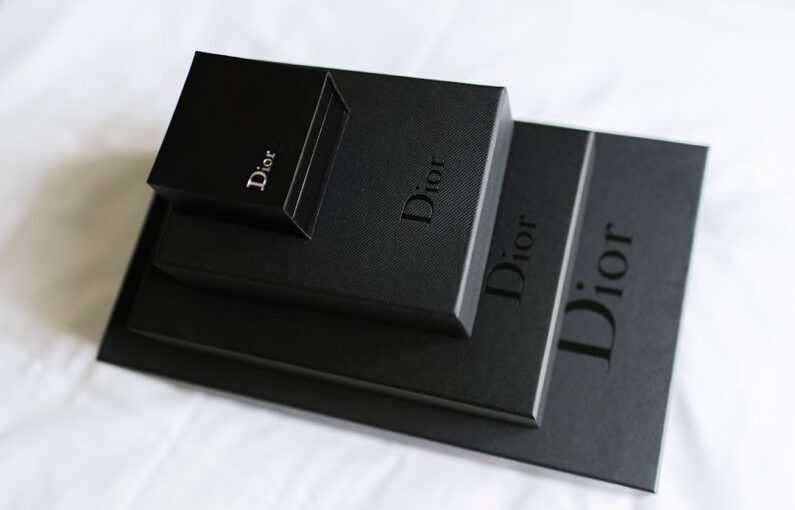 Luxury Gifts - a couple of black boxes sitting on top of a bed