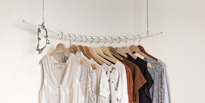 Sustainable Trend - assorted clothes in wooden hangers