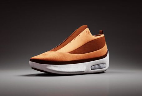 Digital Fashion - a pair of orange and white shoes on a gray background